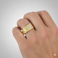 A close-up of a hand wearing the 1/10CTW Diamond Nugget Men’s Ring in 10k yellow gold, featuring a bold lion’s head design with natural diamonds. The background is plain and light gray.