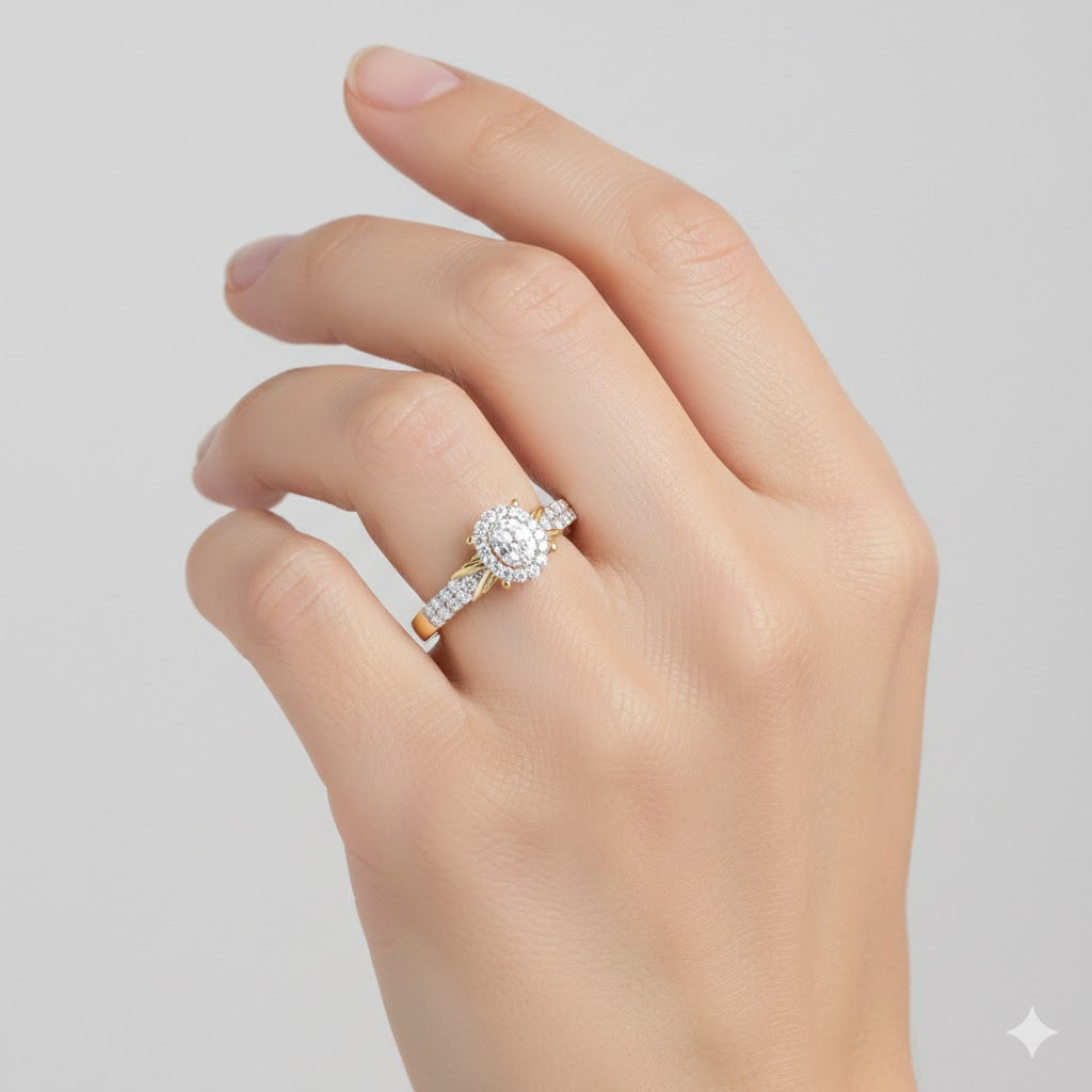 A hand with neatly manicured nails wears the 1/4CTW Diamond Oval Halo Engagement Ring, crafted in 10K gold and featuring an oval center stone encircled by a shimmering diamond halo on a sparkling band.