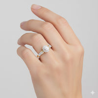 A hand with neatly manicured nails wears the 1/4CTW Diamond Oval Halo Engagement Ring, crafted in 10K gold and featuring an oval center stone encircled by a shimmering diamond halo on a sparkling band.