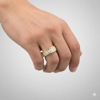A close-up of a hand wearing the 3/8 CTTW Natural Diamond Men’s Band in 14K gold, featuring rectangular clear diamonds, set against a plain light gray background.