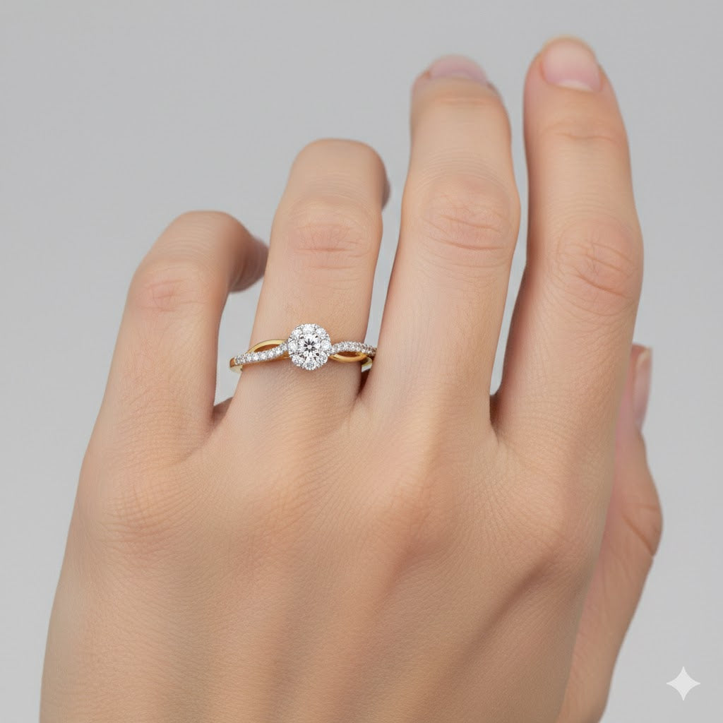 A light-skinned hand shows the 10k Yellow Gold Round Diamond Halo Promise Ring 1/5 Cttw on the ring finger, with a sparkling round diamond against a plain, light background.