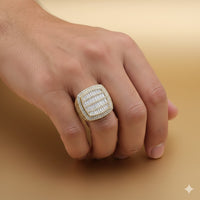 A hand showcases the Cushion Baguette Diamond Ring – 6.07 CT Gold Design, featuring a large rectangular gold setting with rows of diamonds, set against a smooth light tan background.