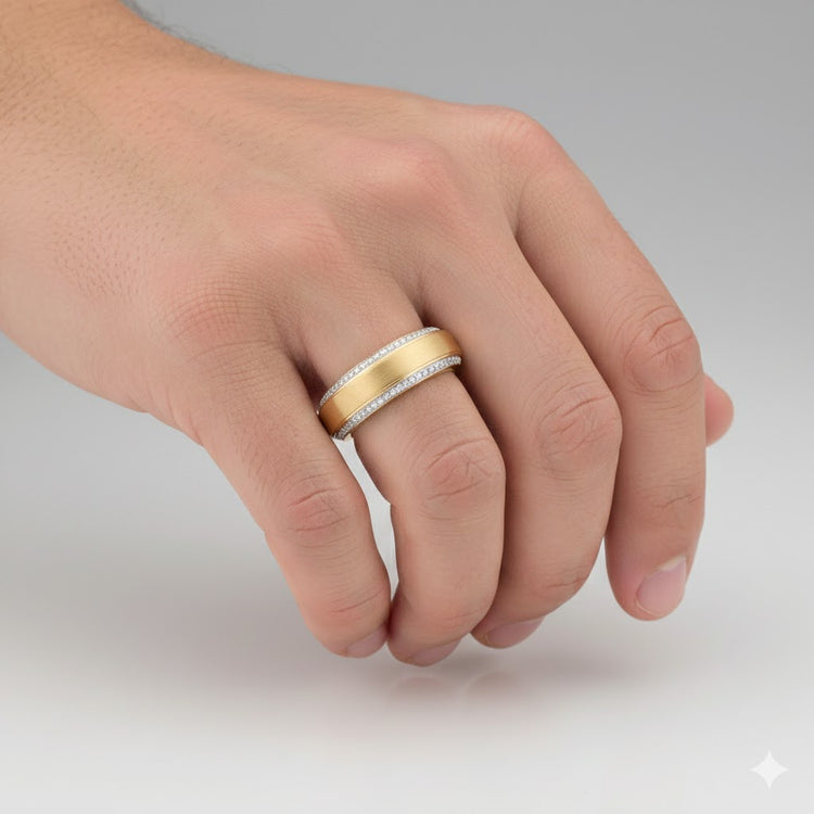 A hand wears the 3/8CTW Men’s Diamond Band in 14K yellow gold, featuring rows of diamonds along each edge, showcased against a plain light background.