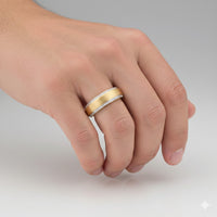 A hand wears the 3/8CTW Men’s Diamond Band in 14K yellow gold, featuring rows of diamonds along each edge, showcased against a plain light background.