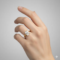 A light-skinned hand wears the 2.08ct Radiant Lab Diamond Solitaire Engagement Ring in 14k solid gold, featuring a large rectangular radiant lab diamond on the ring finger against a plain gray background.