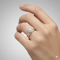 A hand with neatly manicured nails showcases the 3/8 CTW 10k Yellow Gold Wedding Trio Set against a light gray background.