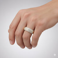 A hand displays the 10k Yellow Gold Diamond Band Ring 1 CT, featuring multiple rows of sparkling diamonds, against a plain light gray background.
