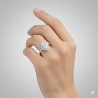 A hand wearing the Pear-Shaped Halo Lab Diamond Engagement Ring with Pavé Band on the ring finger, shown against a plain light gray background.