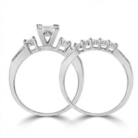 The 14k White Gold Princess Diamond Bridal Ring Set (1 Cttw) features a solitaire princess diamond ring beside a band adorned with five smaller diamonds, making it an ideal wedding or bridal set.