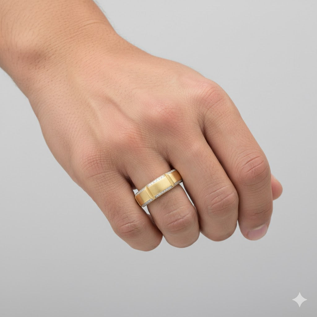 A hand wears the 5/8CTW Diamond Men's Band in 14k Yellow Gold on the ring finger, set against a plain light gray background.