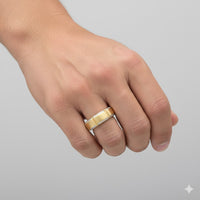 A hand wears the 5/8CTW Diamond Men's Band in 14k Yellow Gold on the ring finger, set against a plain light gray background.