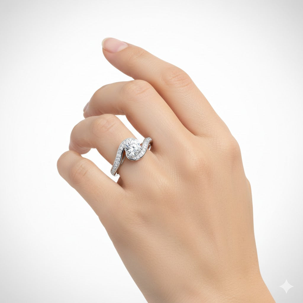 A light-skinned hand wears the Elegant Swirl Halo Lab Diamond Ring – Round Brilliant Stone, showcasing a large round center stone and a curved, stone-encrusted band against a plain white background.