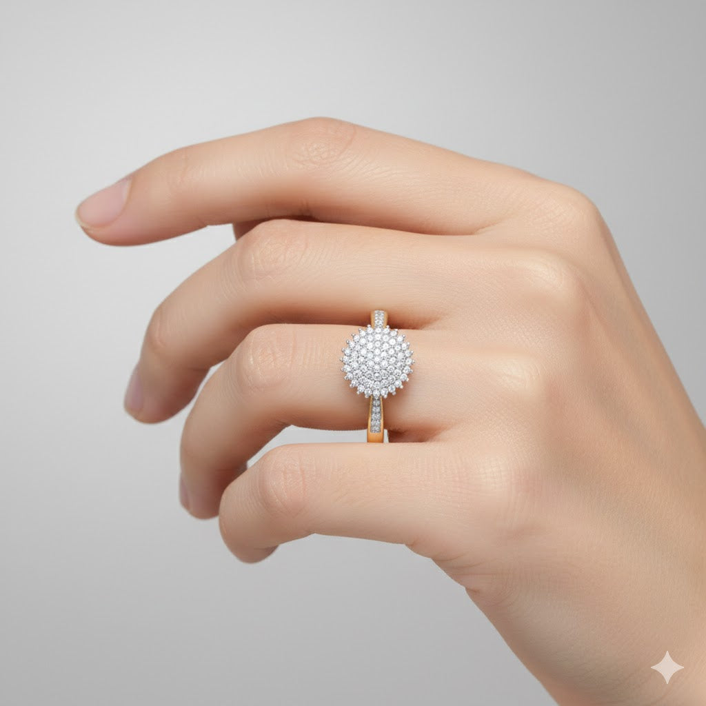 A hand with neatly manicured nails wears the 10k Gold Round Diamond Circle Ring 1/4 Cttw, showcasing its large round cluster of sparkling white diamonds on the ring finger against a plain light gray background.