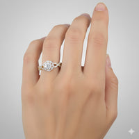 A hand with light skin tone wears the 1/2 CTW Diamond Flower Bridal Ring in 14K gold, showcasing a round center diamond surrounded by smaller diamonds on the ring finger, set against a plain light gray background.