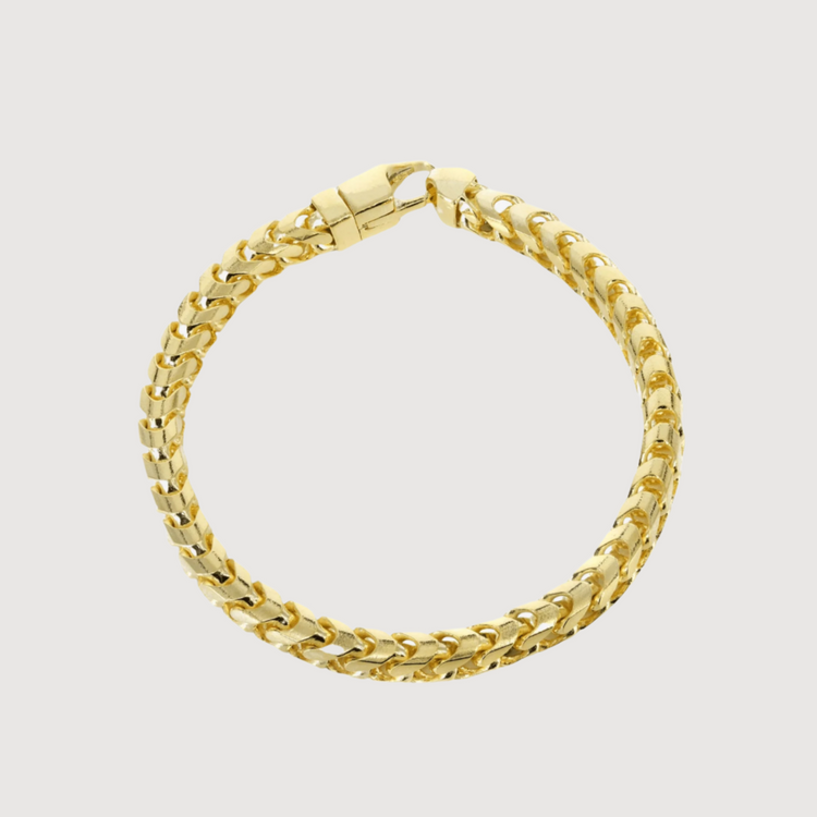 The Hollow Franco Bracelet - 2mm features thick, polished gold links and a secure lobster clasp, displayed in a circular shape on a white background. This minimalist piece adds elegant shine to any outfit.