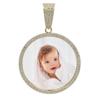 A 10k solid gold picture pendant featuring CZ stones around the edge, personalized with a photo of a smiling baby wrapped in a white towel or blanket.