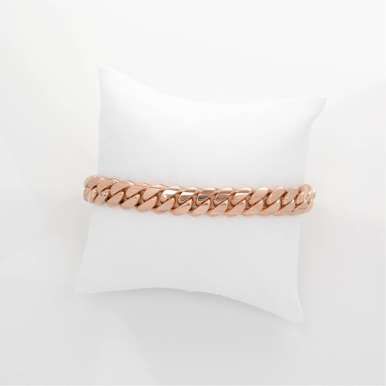 The 8mm Handmade Miami Cuban Link Bracelet in solid 10K, 14K, or 18K gold is shown on a white cushion against a plain white background.