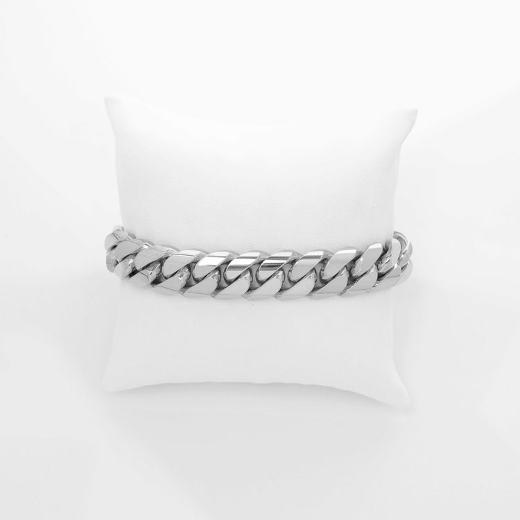 A 13mm Handmade Miami Cuban Link Bracelet in 10K/14K/18K solid gold is displayed on a white cushioned stand against a plain white background.