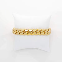A 14mm Solid Gold Cuban Link Bracelet is displayed on a white cushioned stand against a plain white background.