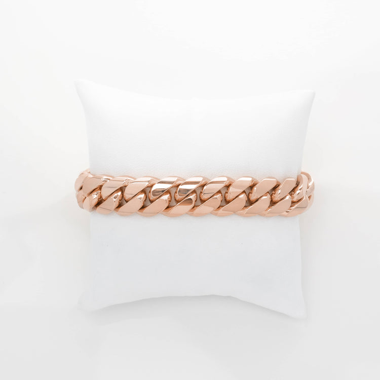 The 14mm Handmade Miami Cuban Link Bracelet in 10K/14K solid gold is displayed on a small white cushion against a plain white background.