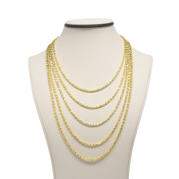 A display bust showcases the 3mm Barrel Crystal Chain, a 14k gold bonded necklace featuring elegant crystal accents on delicate, layered chains of varying lengths.