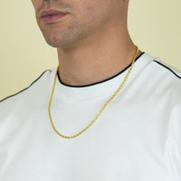 A man wearing a white shirt with black trim and the 3mm Barrel Crystal Chain in 14k Gold Bonded, visible from the shoulders up against a plain, light background.