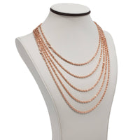 The 3mm Barrel Crystal Chain - 14k Rose Gold Bonded is showcased on a white bust, featuring five elegantly graduated rose gold chains with sparkling crystal accents.