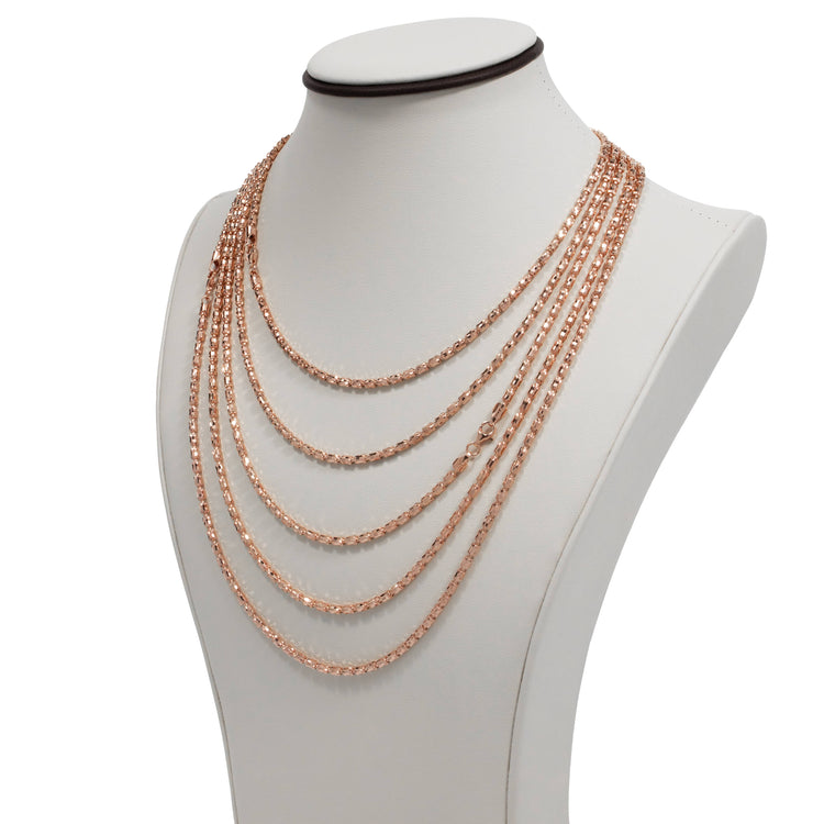 A white jewelry bust displays the 3mm Barrel Crystal Chain, a 14K rose gold bonded necklace featuring sparkling crystal accents.