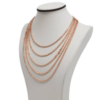 A white jewelry bust displays the 3mm Barrel Crystal Chain, a 14K rose gold bonded necklace featuring sparkling crystal accents.