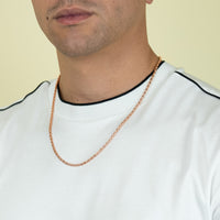 A person wears a white shirt with black trim and a 3mm Barrel Crystal Chain - 14k Rose Gold Bonded necklace. The image shows only the lower half of the face, neck, and upper chest against a light background.