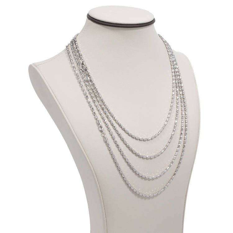 A white jewelry bust showcases a 3mm Barrel Crystal Chain necklace crafted in 925 silver, layered with five strands of varying lengths for an elegant and sparkling style.