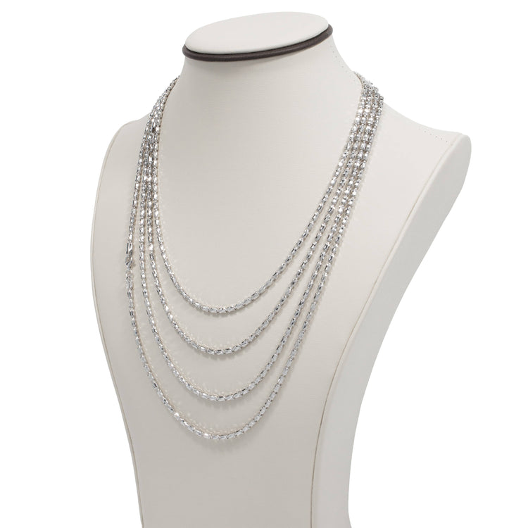 The 3mm Barrel Crystal Chain showcases 925 silver with five graduated strands for a layered look, beautifully displayed on a white jewelry bust.