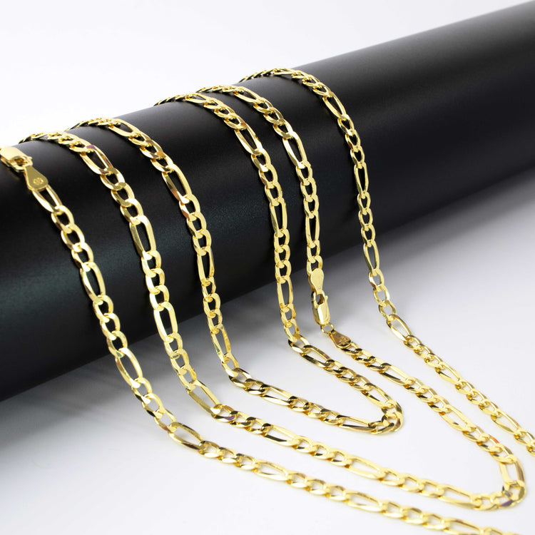 Multiple Figaro Chain 8mm - 14k Gold Bonded necklaces with elongated links are draped over a sleek black cylindrical rod, set against a white background.
