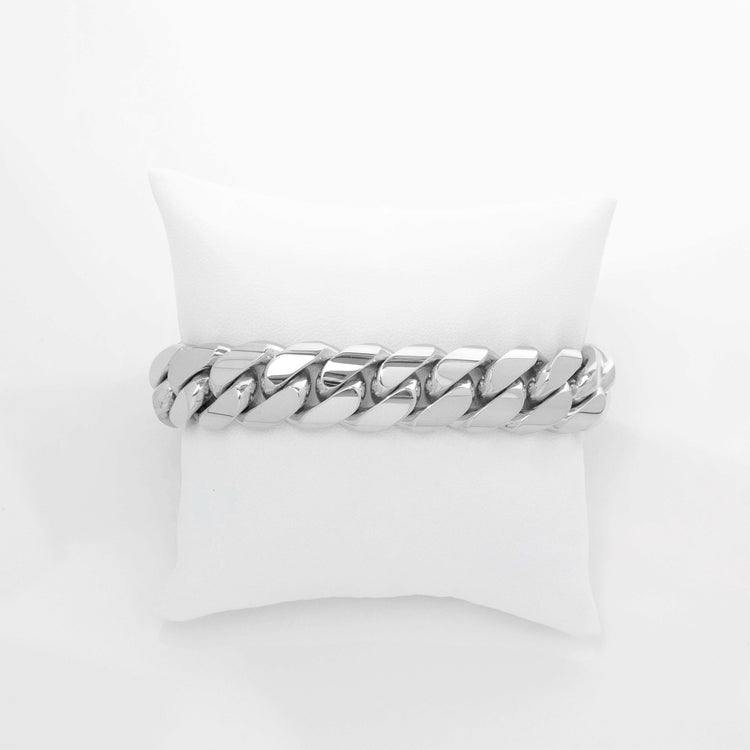 A 16mm Handmade Miami Cuban Link Bracelet in 10K/14K solid gold is displayed on a white cushion against a plain white background.