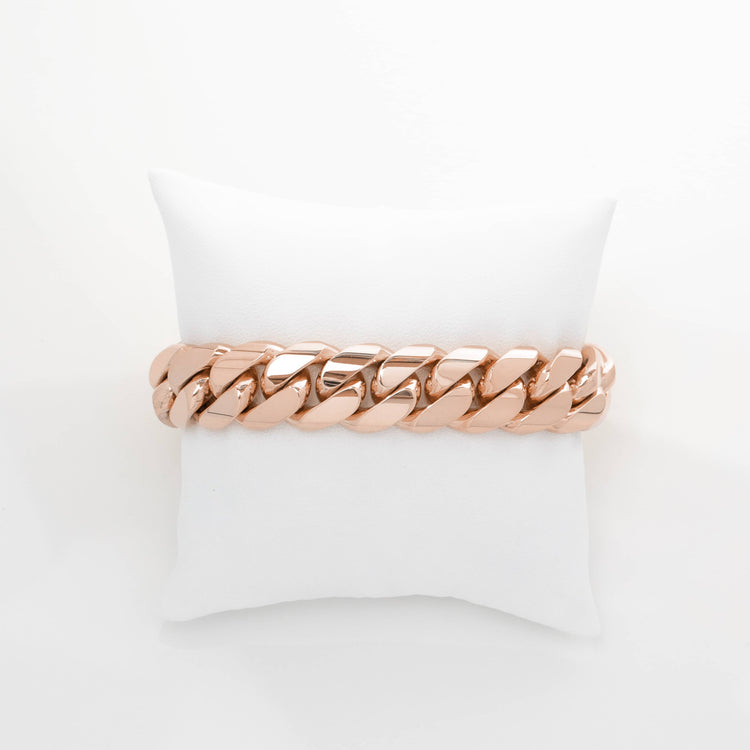 A 16mm Handmade Miami Cuban Link Bracelet in 10K/14K solid gold is displayed on a white cushioned pillow against a plain white background.