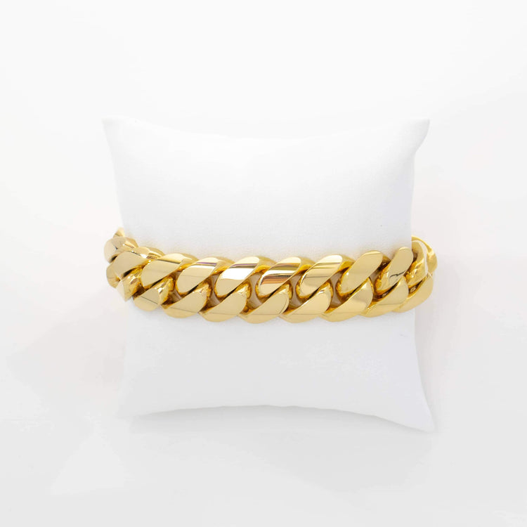 The 17mm Handmade Miami Cuban Link Bracelet in 10K/14K Solid Gold is displayed on a white cushion against a white background.