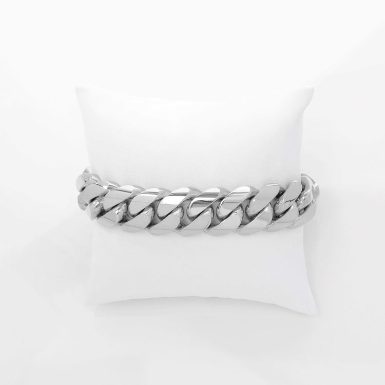 A bold 17mm Handmade Miami Cuban Link Bracelet in 10K/14K solid gold, elegantly displayed on a white cushion against a plain white background.