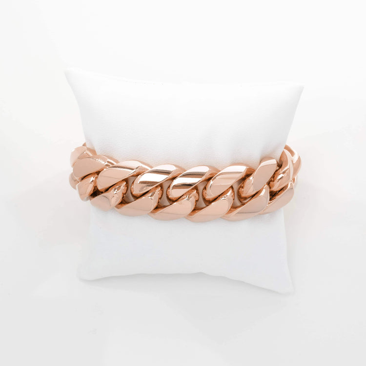 The 20mm Handmade Miami Cuban Link Bracelet in solid 10K/14K gold is displayed on a white cushion against a plain white background.