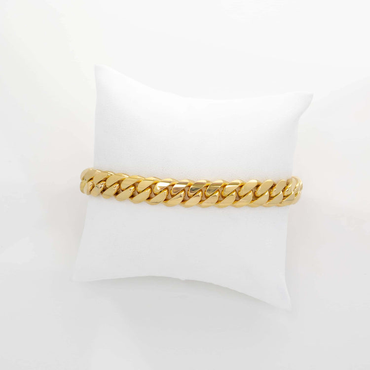The 9mm Handmade Miami Cuban Link Bracelet in solid 10K, 14K, or 18K gold is displayed on a white cushion against a plain white background.