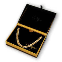 The Cuban Link Chain 10mm - 14k Gold Bonded is showcased in an open black and gold jewelry box with the Goldzenn logo inside, making it a stylish addition to any men's jewelry collection.
