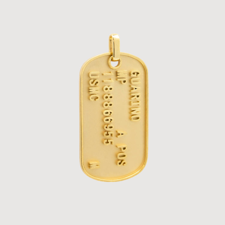 The Custom Military/Dog Tag Pendant is a gold pendant with embossed text—name, blood type, ID number, and USMC—hanging from a small loop at the top.