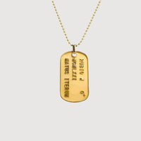 The Custom Military/Dog Tag Pendant with embossed text hangs from a gold beaded chain, displayed on a plain light background.