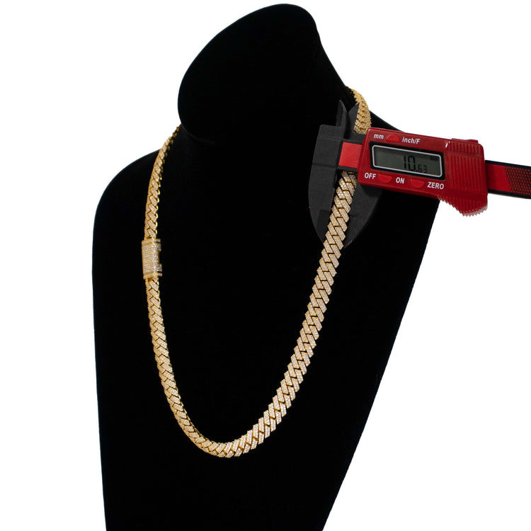 A Diamond Cuban Link Chain Prong in solid 14k yellow gold is displayed on a black velvet bust, with a digital caliper measuring the chain’s thickness at 11.63mm.