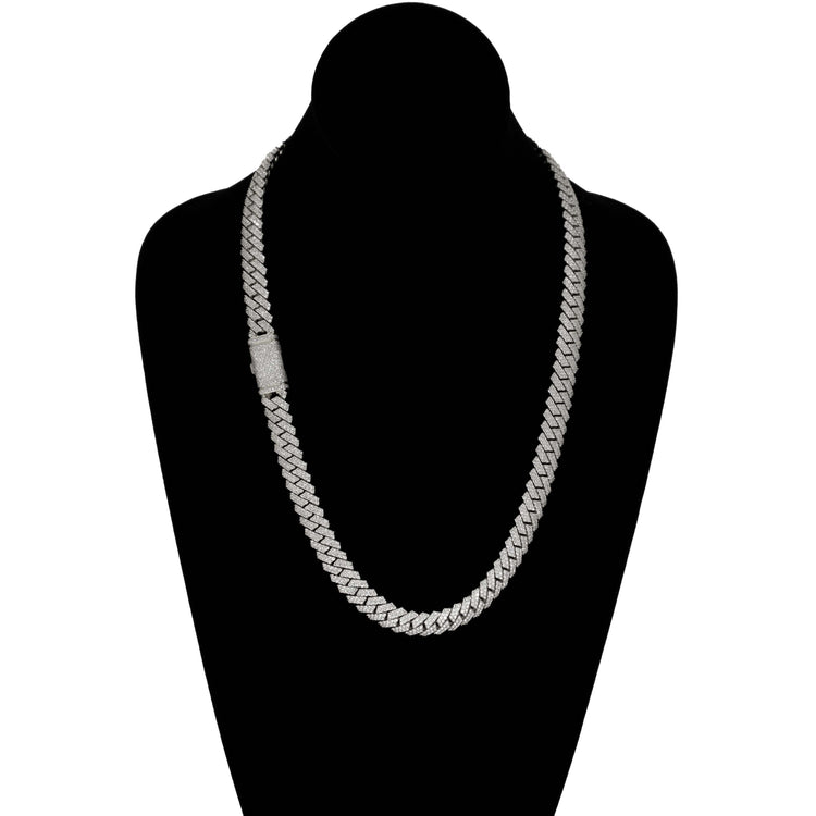 The Diamonds Cuban Link Chain (8mm-17.5mm) in solid white gold features a flat, interlocking silver design and a rectangular clasp with sparkling stones, elegantly displayed on a black velvet bust.