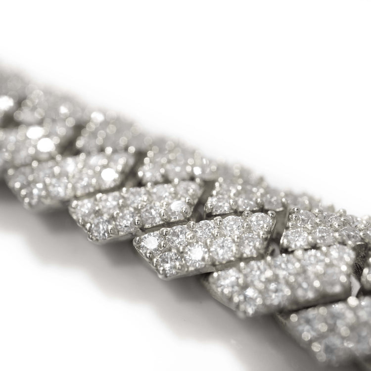 Close-up of the Diamonds Cuban Link Chain, 8mm-17.5mm in solid white gold, showcasing large interlocking links encrusted with sparkling natural diamonds against a white background.