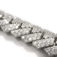 Close-up of the Diamonds Cuban Link Chain, 8mm-17.5mm in solid white gold, showcasing large interlocking links encrusted with sparkling natural diamonds against a white background.