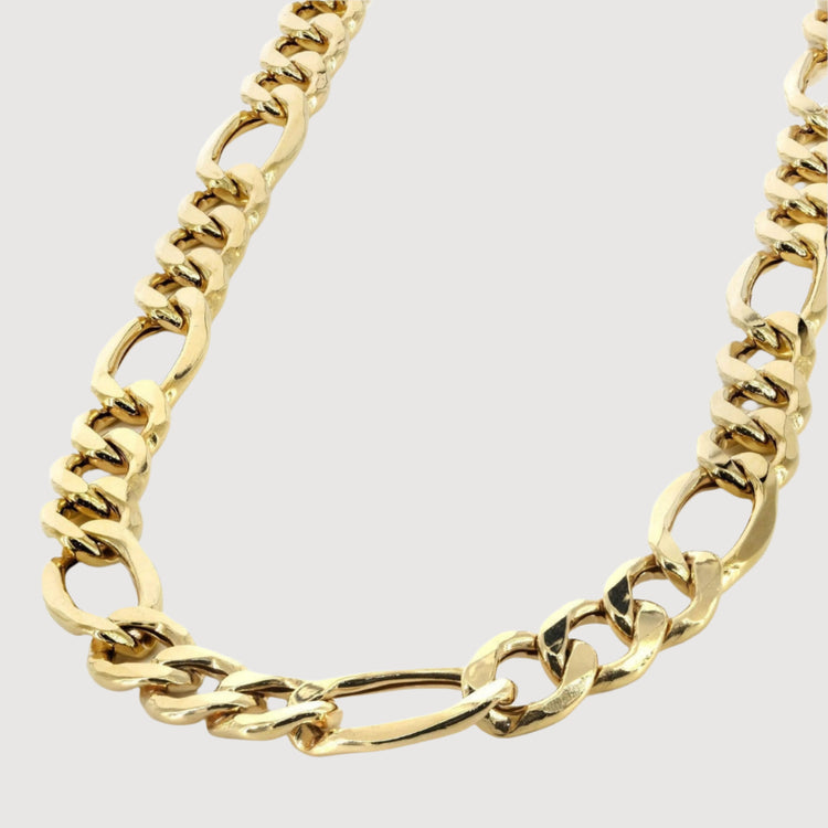 A close-up of the Figaro Chain 3mm – Solid Yellow Gold, featuring large interlocking oval links in 14K yellow gold, displayed on a white background—an elegant men's jewelry choice.
