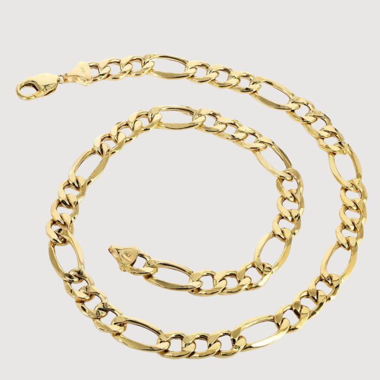 The Figaro Chain 8mm – Solid Yellow Gold features alternating short and elongated oval links with a lobster clasp, coiled on a plain white background for a timeless look.