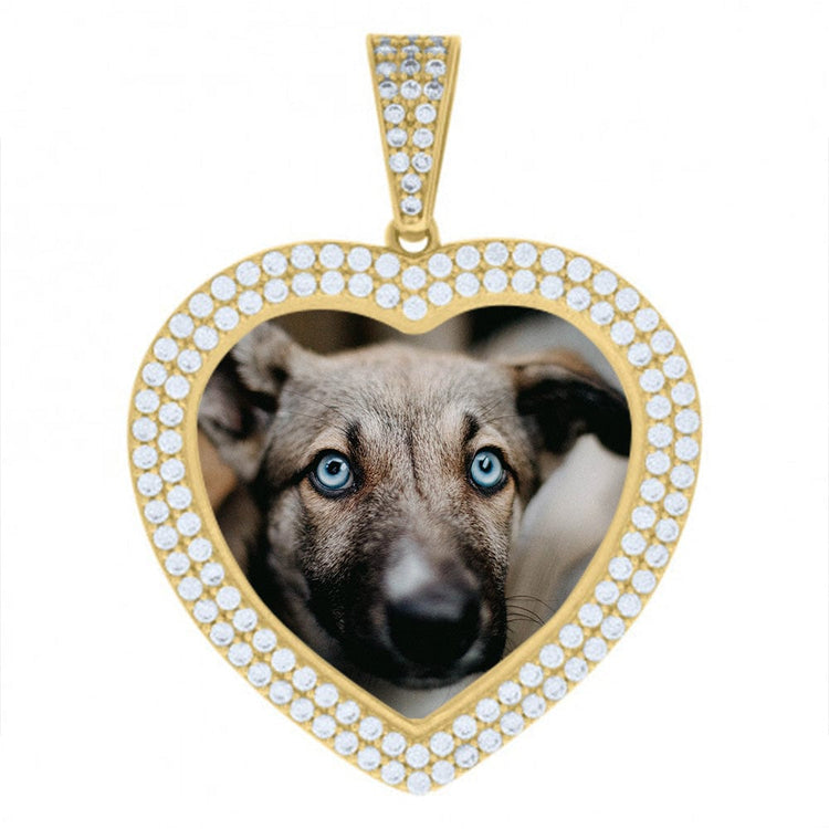 The Heart Frame Charm Picture Pendant in 10k Solid Gold is heart-shaped, diamond-encrusted, and features a close-up photo of a blue-eyed dog inside its personalized picture frame.