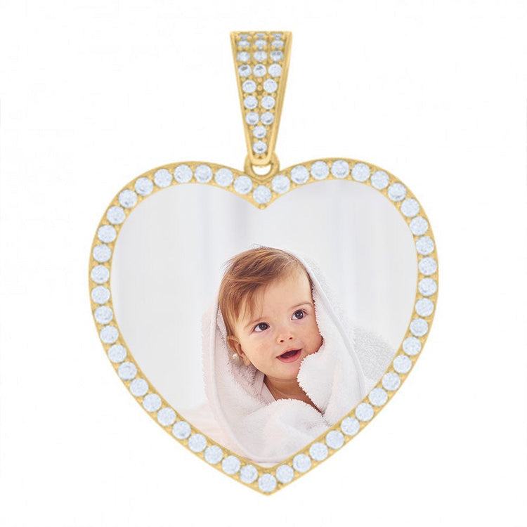 The Heart Picture Pendant in 10k Solid Gold is a heart-shaped pendant outlined with small white gems, featuring a photo of a smiling baby wrapped in a white towel.